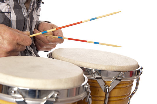 Man playing bongo with sticks