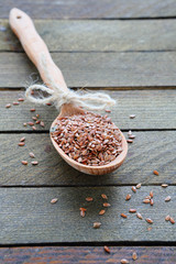 flax seeds on wooden spoon