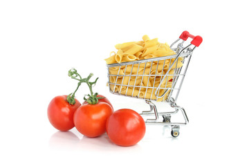 Pasta in mini shopping cart with tomatoes
