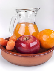 apple, orange and carrots with fresh juice in the background