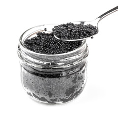 Fototapeta na wymiar Black caviar in a glass jar with spoon isolated on white