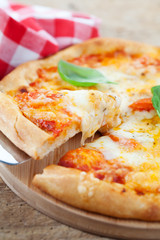 Slice of homemade pizza being lifted up