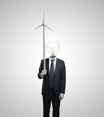 businessman holding wind turbine