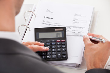 Businessman Using Calculator