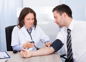 Young Doctor Checking Blood Pressure