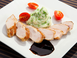 Pork tenderloin w potato puree with young peas