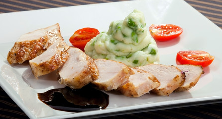 Pork tenderloin w potato puree with young peas