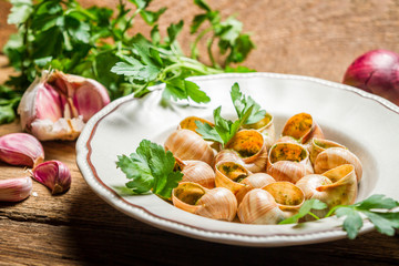 Closeup of baked snails with garlic butter
