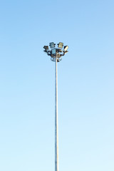 spotlight tower in bright blue sky
