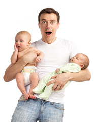 Shocked young man with two babies over white