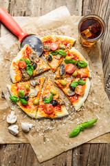 Cutting homemade pizza with basil