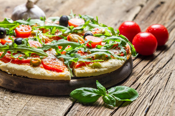 Freshly baked pizza with basil and tomatoes