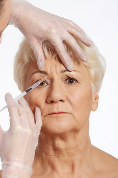 An old woman having a injection- beauty concept.