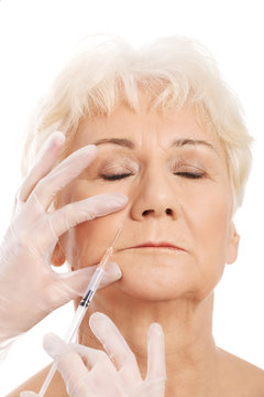 An old woman having a injection- beauty concept.