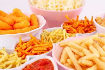 Potato, corn and wheat chips in bowls