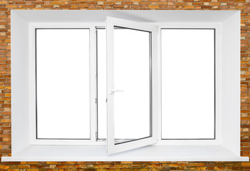 White plastic triple door window on brick wall with cutout area