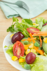 Salad with vegetables on white plate