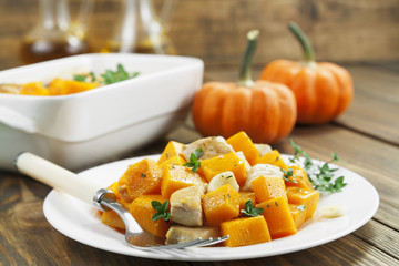 Baked pumpkin with chicken. garlic and herbs