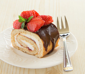 Chocolate swiss roll cake with strawberries