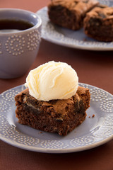 Chocolate brownie cake with a scoop of ice cream.
