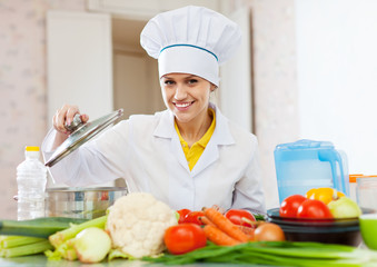  cook in uniform with vegetables in kitchen