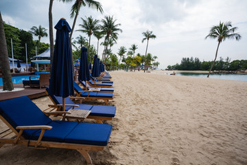 Deck chairs on the beach of Sentosa Island in Singapore.