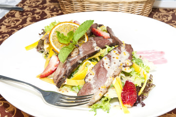 salad of duck meat and vegetables in a restaurant