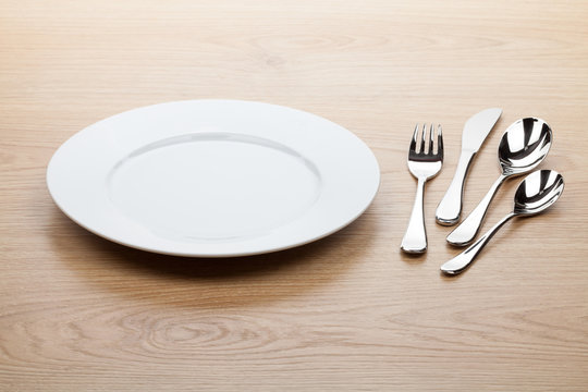 Empty white plate with silverware