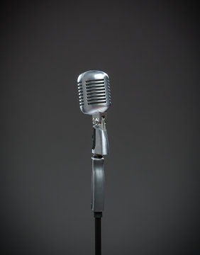 Close up of silver microphone on grey
