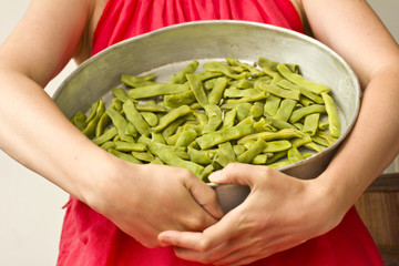 Beautiful girl holding a green pea