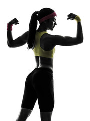 woman exercising fitness flexing muscles silhouette rear view © snaptitude
