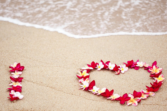 Flower love symbol on sand