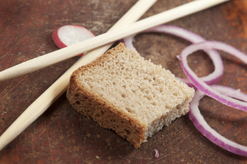 Still life with chopsticks, bread and vegetables