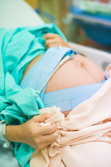 pregnant female feeling the pain of contraction labor in hospita