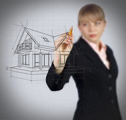 Obraz premium Business woman drawing house on screen. Real estate concept