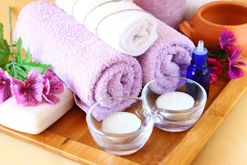 Spa and wellness setting with natural soap, candles and towel