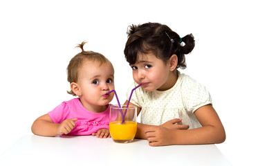 little girls with glass of orange juice