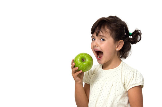 Little Girl Eating An Apple Isolated On White