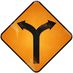 Fork road sign. Damaged yellow metallic road sign with fork symb