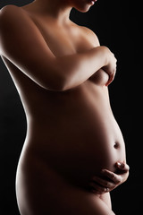 Naked Pregnant Woman/Nude pregnant woman. Low key studio photogr