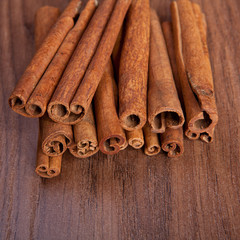 cinnamon sticks on wooden background