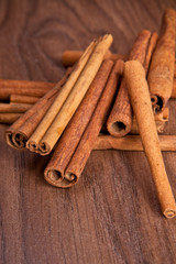 cinnamon sticks on wooden background
