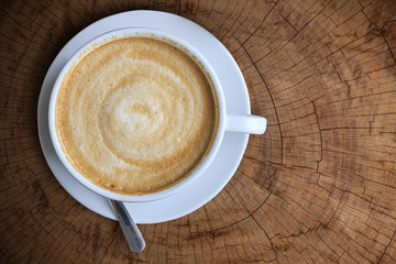 Top view of White ceramic cup of coffee on wood table