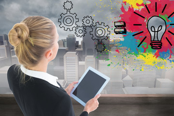 Composite image of businesswoman holding tablet