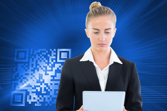 Composite image of businesswoman holding tablet