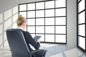 Composite image of businesswoman sitting on swivel chair with ta