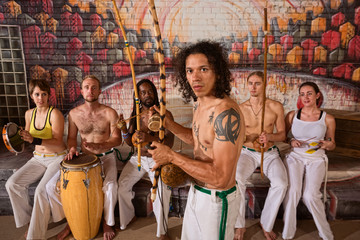 Fototapeta na wymiar Latino Capoeira Performer with Group