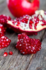 broken pomegranate on wooden surface
