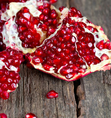 broken pomegranate on wooden surface