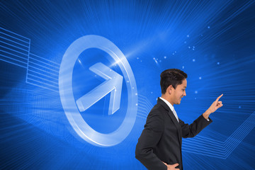 Composite image of smiling asian businessman pointing